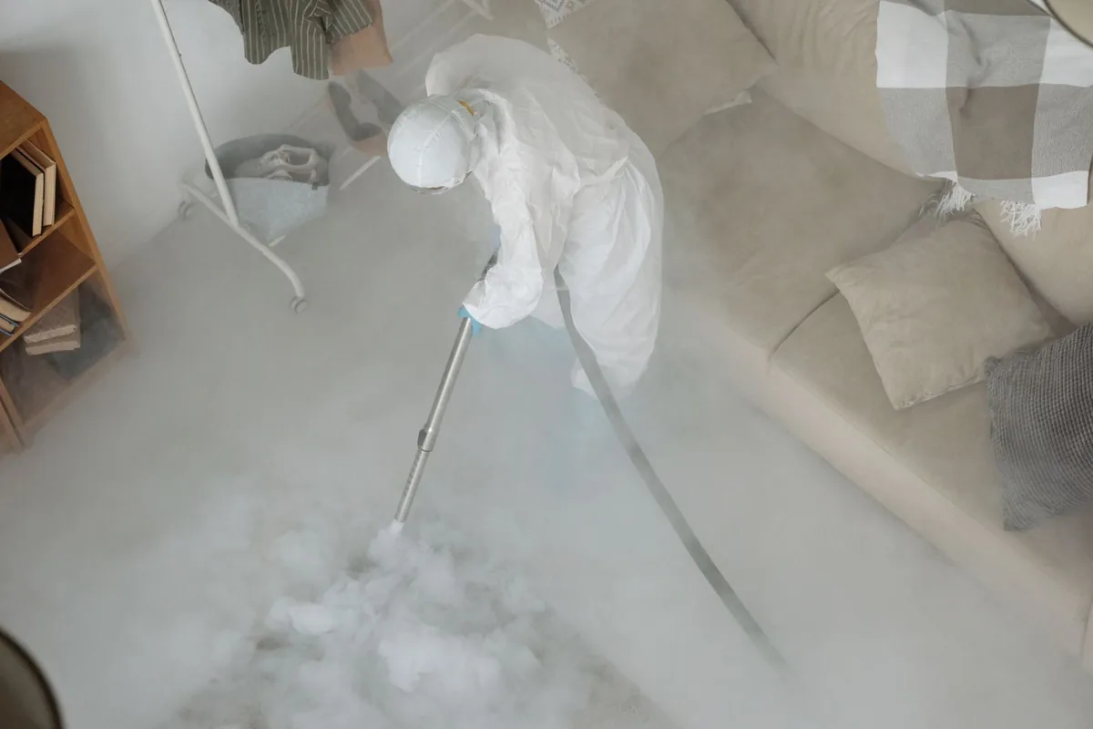 Biohazard cleanup technician in protective equipment, King Field, Minneapolis, MN